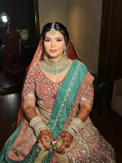 A full view of my bride in her Bindani outfit. The soft makeup perfectly complements the intricate, multi-colored embroidery.