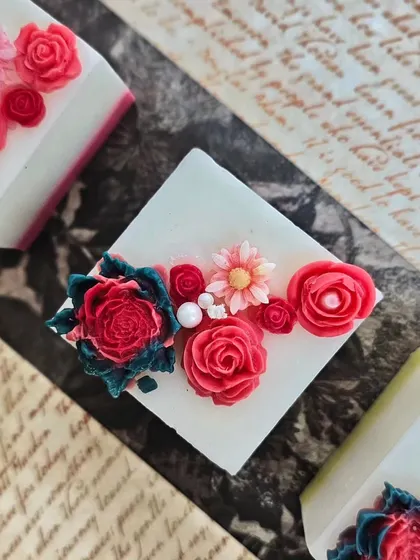 A detailed shot of the floral arrangement on the Regal Pillar Candles. Each flower is carefully placed to create a stunning, three-dimensional effect.