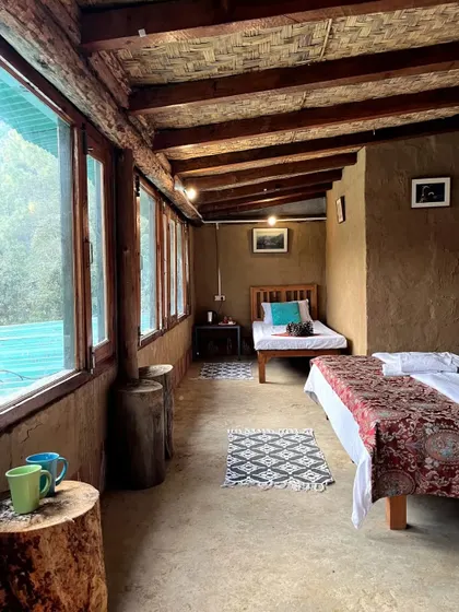 The interior of our shared rooms, featuring mud walls and a wooden ceiling for a cozy, earthy feel. It's the perfect base camp for our MTB workshops and hiking trips.