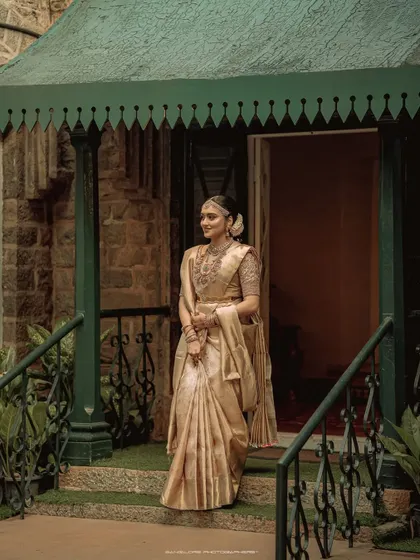 The bride stands at the doorway, a picture of grace and anticipation. This portrait captures the feeling of stepping into a new life.
