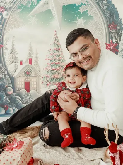 A precious moment between father and daughter. Their happy smiles during this winter wonderland themed Christmas shoot are just heartwarming.