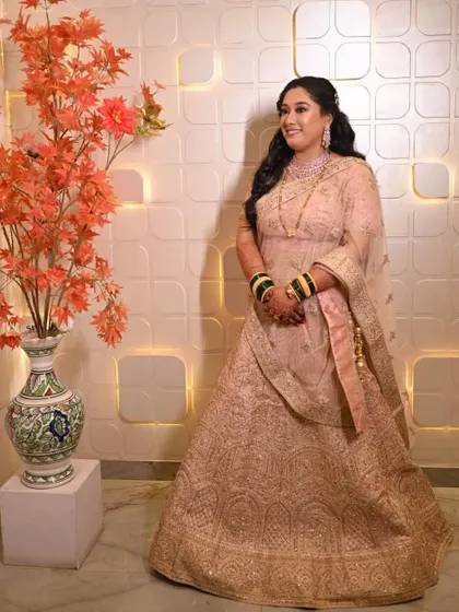 Another shot of this elegant reception look. The soft waves in her hair and the glowing makeup create a timeless and sophisticated style.