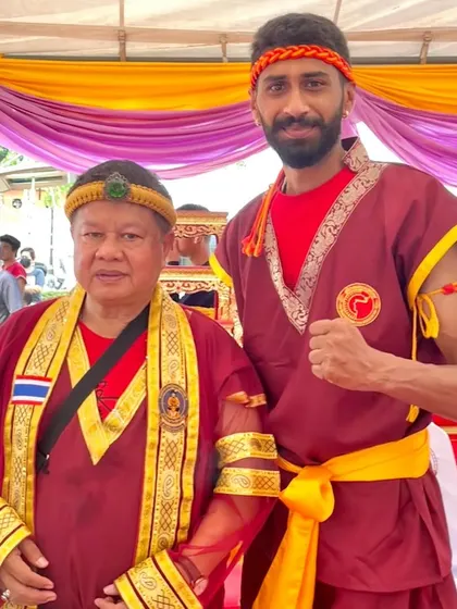 With my master, Grand Master Woody, during a traditional ceremony. I am honored to learn from and stand by a legend of Muay Thai.