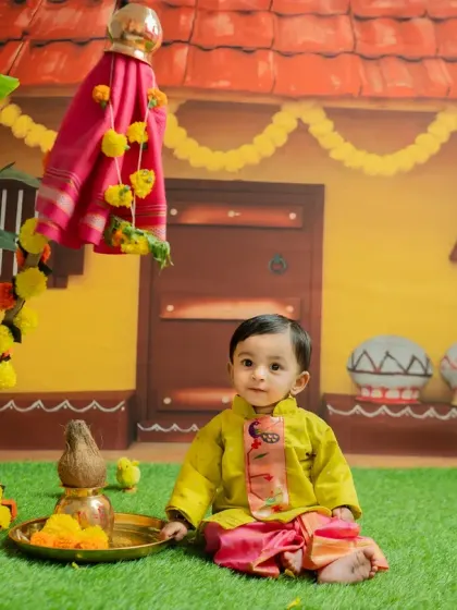 A beautiful portrait for a Gudi Padwa themed shoot. The baby is dressed in a traditional kurta and dhoti, sitting in a festive setting that celebrates the Marathi new year.