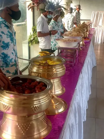 A large brass serving pot filled with hot Gulab Jamuns. This is one of the most requested desserts for parties and weddings, and I make sure they are soft and soaked in syrup.