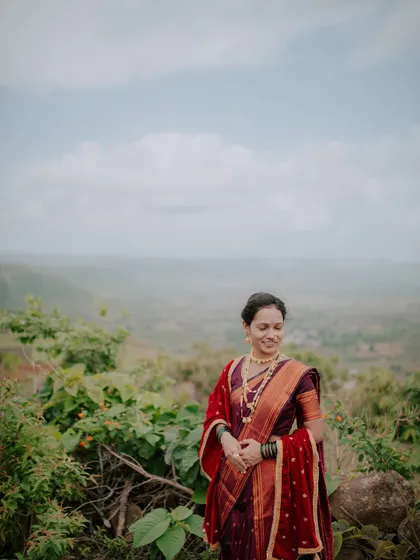 A candid shot of the bride-to-be smiling, captured during her outdoor pre-wedding photoshoot.