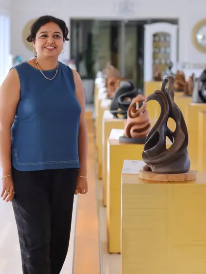 Artist Aarti Bhadauria stands proudly with her collection of terracotta sculptures. We are dedicated to showcasing artists who master unique mediums, bringing diverse forms of expression like these earthy, emotive sculptures to our audience.