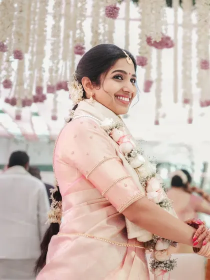 A beautiful portrait of the bride looking over her shoulder, her smile lighting up the frame. We excel at capturing flattering and natural bridal portraits.
