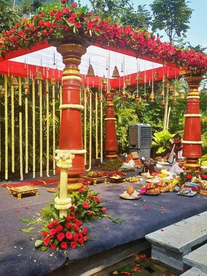 A full view of the red-pillared South Indian mandap, showcasing the complete setup for the wedding rituals.
