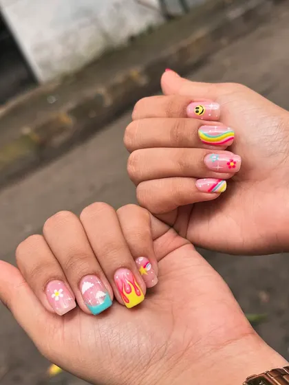 Bringing all the good vibes with this fun, retro-inspired set. Each nail tells a different story with hand-painted art, including smiley faces, daisies, rainbows, flames, and clouds. This is for when you want your nails to be as playful as you are.