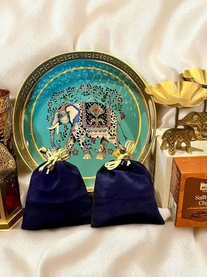 I designed this traditional yet luxurious Diwali hamper with an ornate elephant-themed tray, brass diya holders, a copper tumbler, and saffron chai. It's a perfect gift for clients who appreciate artisanal craftsmanship.
