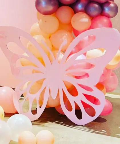 It's all in the details. This large, custom-made butterfly cutout was a key element in bringing the whimsical theme to life, adding a beautiful three-dimensional effect to the balloon decor.