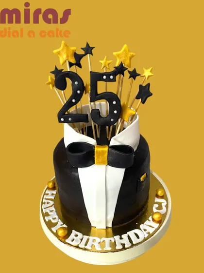 A sharp and stylish tuxedo cake for a 25th birthday. The black and white design with a golden bow tie is topped with sparkling stars, making it a dapper choice for a milestone celebration.
