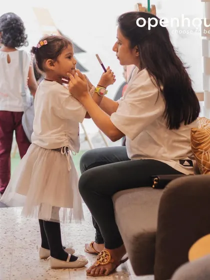 A quiet moment of connection between a mother and child before class begins. These small interactions are the foundation of the trusting, warm community we strive to build.