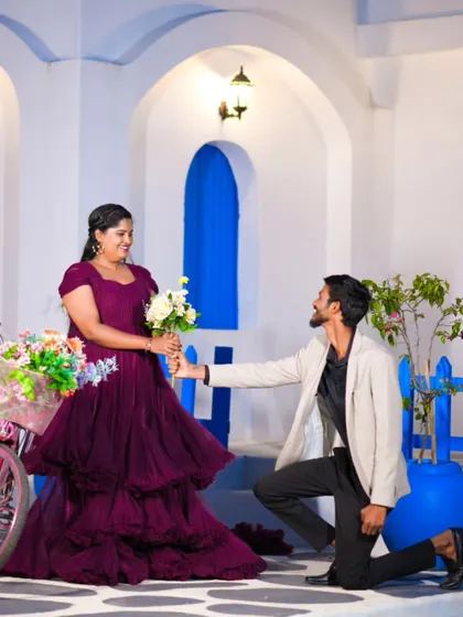 A playful moment where the groom-to-be offers a bouquet to his partner. It's these small, romantic gestures that make a shoot special.