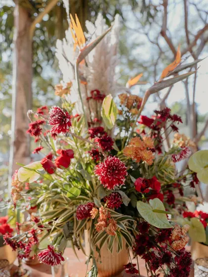 The bird of paradise flower added a unique, structural element to this vibrant red floral arrangement, showcasing our creative approach to composition.