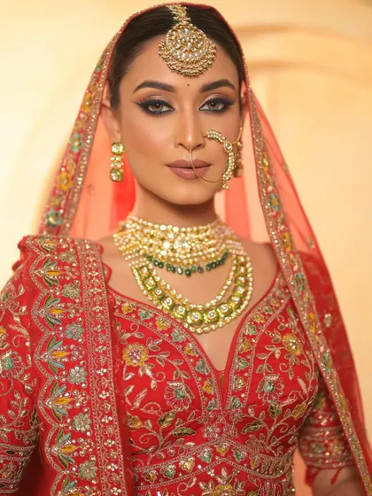 The bride's direct gaze is powerful and confident. The sharp eye makeup and flawless skin make for a truly unforgettable bridal look.