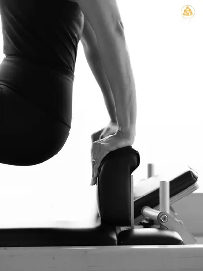 A close up on the hands during a challenging upper body exercise. Every detail matters in Pilates, from your grip to your alignment, to ensure you are moving with intention.