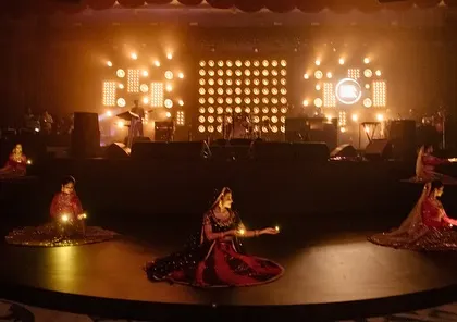 Kathak dancers perform on a satellite stage, their graceful movements and traditional attire adding a layer of cultural richness to the contemporary 'Raga Saga' event.