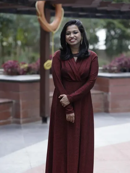 A full-length view of the elegant maroon wrap dress. It's a versatile piece that's perfect for a formal dinner or a special event.
