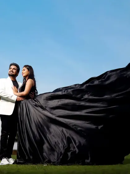 Our black flying gown is perfect for creating high-contrast, dramatic couple portraits. The long, flowing satin trail makes a bold statement against any background.