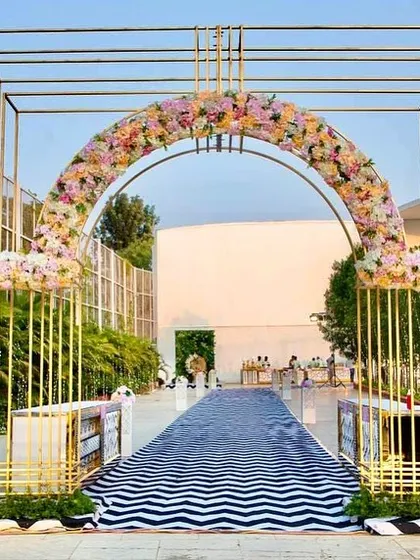 This modern metal archway was fabricated by our team to create a stunning entrance for an outdoor reception.