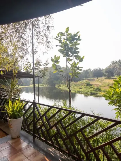 The balcony of our riverside cottage at Kanakapura, offering serene views of the water and surrounding greenery.