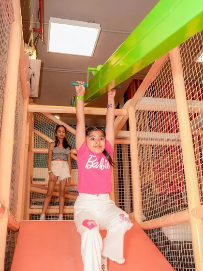 A girl enjoys the zipline feature in our play structure, a thrilling ride from one end to the other.