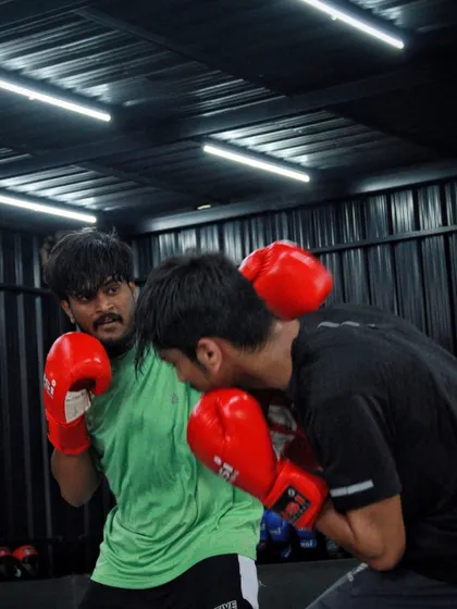 A fighter ducks under a punch, preparing to throw a counter. We drill these defensive movements until they become second nature.