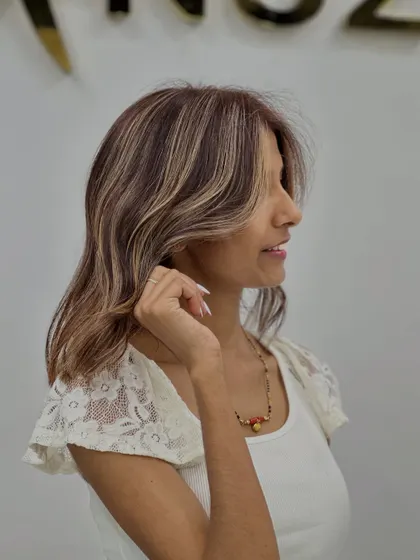 A side profile of the soft beige blonde highlights, showing how they frame the face.