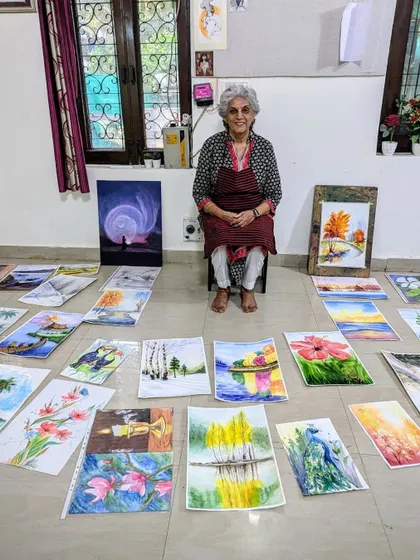 Surrounded by her art, Harinder ma'am is a testament to what dedication and passion can achieve. Here she is with her collection of beautiful watercolor landscapes.