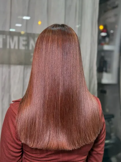 This sleek, straight look with a vacation vibe is the result of a smoothing treatment and a beautiful color service. No filter needed for this glow.