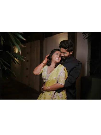 Another beautiful evening shot of the couple, capturing a candid moment of affection and happiness during their engagement celebration.