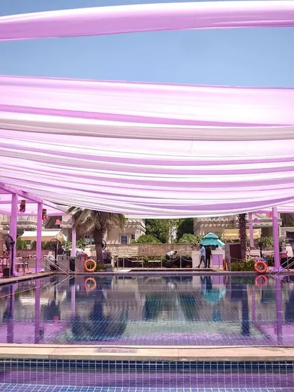 Another perspective of the extensive drape work over the pool, showcasing the scale of the production and the seamless, dreamy effect it created.