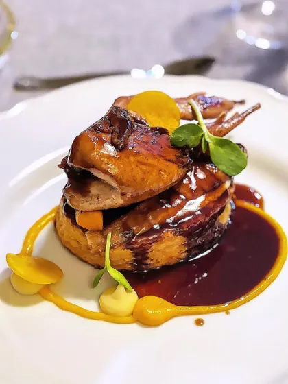 A dish I call "Caille en sarcophage," which translates to quail in a coffin. This classic French preparation features a whole roasted quail presented in a puff pastry case, a true showpiece for a special dinner.