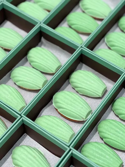 The custom desserts we created for The Face Shop. These delicate madeleines were coated in a light green chocolate to match their brand's aesthetic, showcasing our ability to create themed treats for corporate partners.