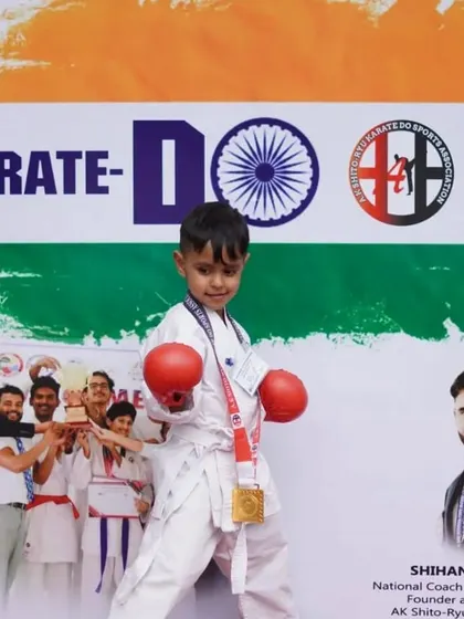 A young champion stands proudly with his gold medal at one of our hosted events. We aim to create a platform where young talent can shine.