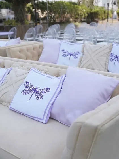 Custom-printed cushions with a dragonfly motif, matching the lavender color scheme of Reeya and Parth's wedding.