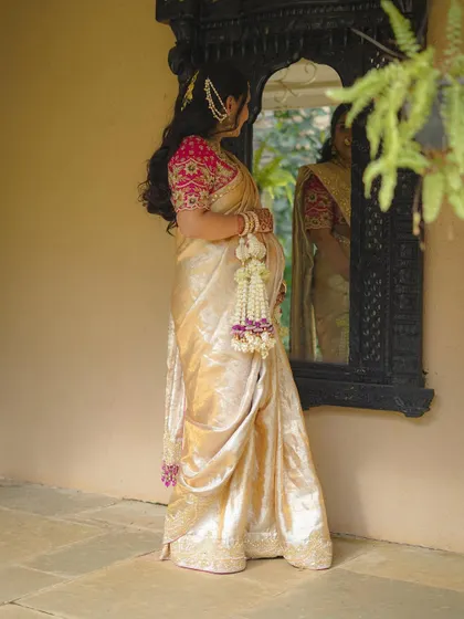 A beautiful, reflective shot of the mother-to-be looking into a traditional mirror.