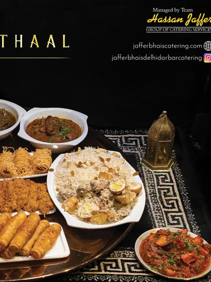 A closer look at the components of our Thaal, including biryani, fried starters, spring rolls, and rich curries, all arranged beautifully on a traditional mat.