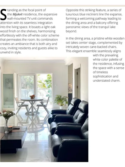 (2/3) Opposite the striking TV unit, a series of luxurious blue recliners line the expanse, leading to a dining area with panoramic views.