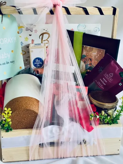 Our baby shower hamper, beautifully wrapped in pink tulle with a "Hooray!! a lovely little Baby is on its way" tag, ready to be gifted.