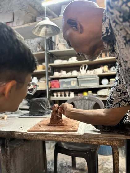A close-up of me guiding a young participant. Teaching the next generation to create with their hands is at the heart of what we do.