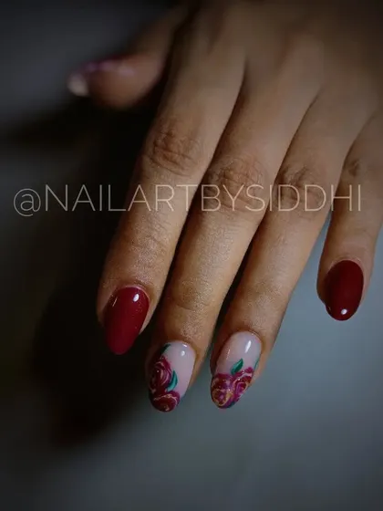 A slightly different angle of the red rose nail art, showing the rich, romantic colors.