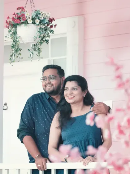 A sweet, candid moment on the porch of a pink house set. We look for natural interactions and expressions to capture the couple's bond.