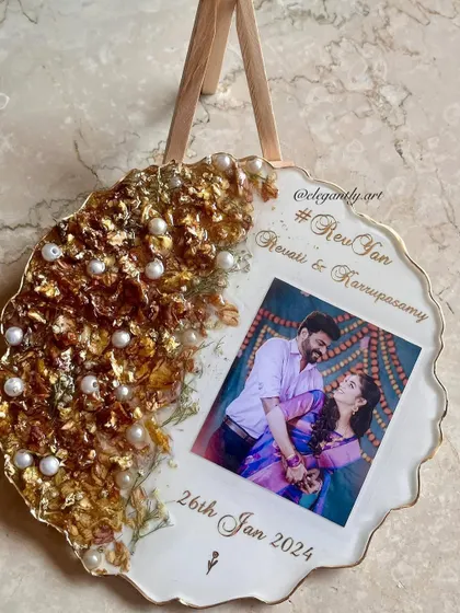 Capture your special moment for eternity with this photo frame. It features intricate varmala designs on one side and your unforgettable moments on the other.