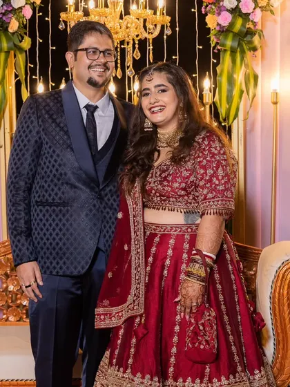 A happy couple at their reception. The bride's makeup is glamorous yet natural, with a focus on her radiant smile.