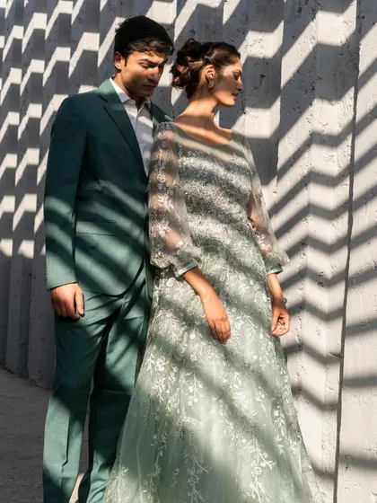 Yes, we do menswear too. This couple is styled in complementary shades of green, with her in an embroidered mint gown and him in a sharp, modern green suit.