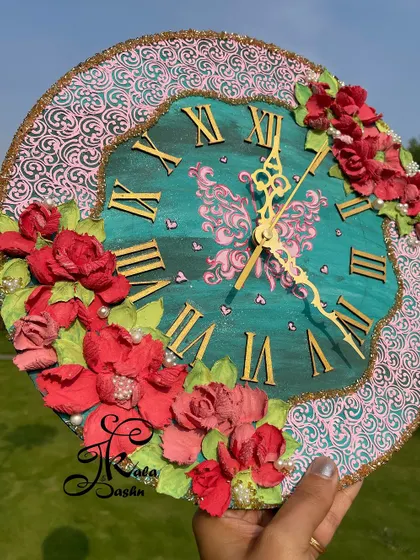 The full 12-inch wall clock with a unique wavy border, combining a teal face with pink textured accents and bold red flowers.