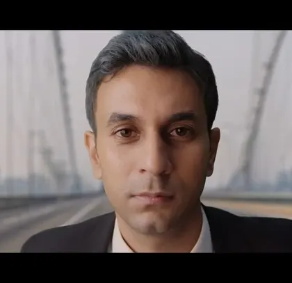 This still from the Air India commercial shows a character looking towards the future with determination. His professional attire helps to convey a sense of purpose and ambition.